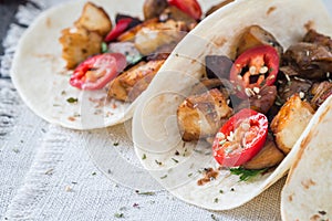 Close up of tacos with grilled mushrooms, Spanish spicy sausage chorizo, Mexican tortillas, Cypriot cheese halloumi, hot chilly