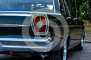 Close up of the tail light of a classic car from the sixties