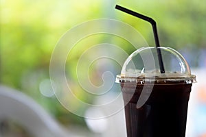 Close up of take away plastic cup of iced Americano