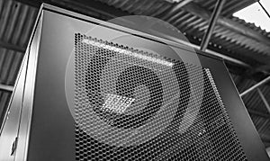 Close-up of a tall Computer and Networking Server cabinet seen within a factory.