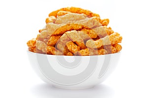 Close up of tangy Potato Puff Snacks sticks, Popular Ready to eat crunchy and puffed snacks sticks tangy spicy  orange color over