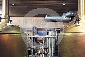 Close up of tanks and equipments in modern interior of brewery. Manufacturable process of brewage. Tanks and tubes in an