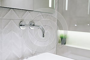 Close up of a tap in stylish modern bathroom interior