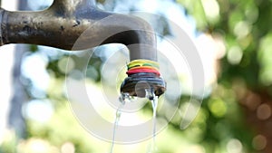 Close up tap water pouring from faucet