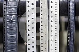 Close up tape and chips material for PCB LED SMT assemble electronic board at feeder unit of automatic pick and place machine