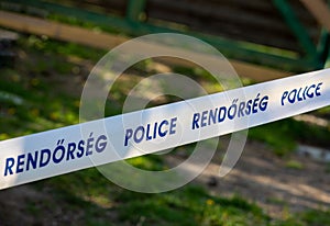 a close-up with a tape with the inscription Police in English and Hungarian language