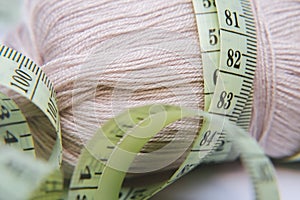 Close up of tape measure and wool background. Concept picture of garment making.