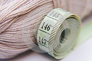 Close up of tape measure and wool background. Concept picture of garment making.