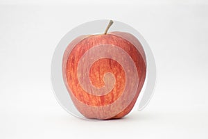 Close up of a tasty red pulpy apple with white background.