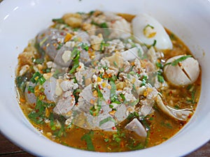 Close up of tasty spicy noodle pork soup  Guay Tiao Tom Yum Moo  - delicious and healthy street food in Thailand photo