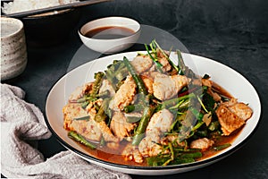 Close up Tasty Stir-fried pork and red hot curry paste with or long bean and Ingredients are oyster sauce, fish sauce, sugar,