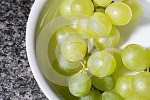 Close up of tasty whine grapes in white bowl