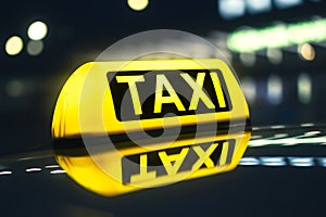 Close-up of taxi sign on car at night