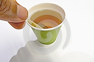 Close up tea bag in paper cup