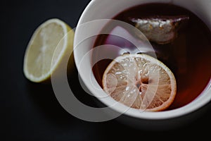 Close up of a tea cup with lemons