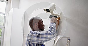 Close-up Of Technician Adjusting CCTV Camera