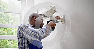 Close-up Of Technician Adjusting CCTV Camera