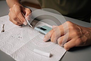 Close-up of technician cleaning smartphone using specialized tools sitting at table, ensuring optimal quality and device