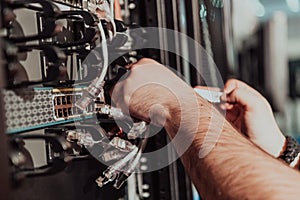 Close up of technician setting up network in server room