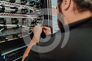Close up of technician setting up network in server room
