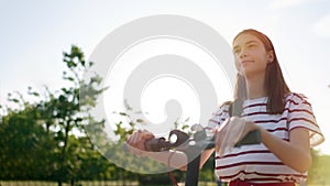 Close up of teen riding electric kick scooter