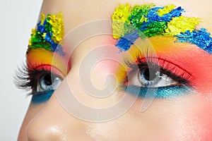 Close-up of teenager girl portrait with unusual face art make-up with paint on brows