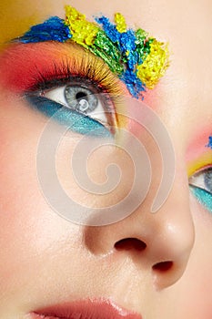 Close-up of teenager girl portrait with unusual face art make-up with paint on brows