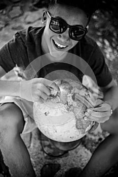 Close up of teenager holding a globe of world photo