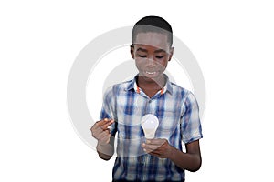 close-up of a teenager looking at a light bulb, smiling