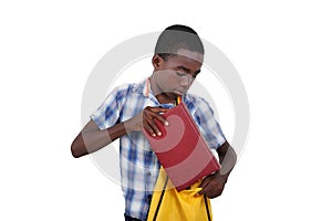 close-up of a teenager storing a book in his bag