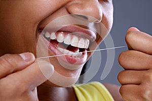 Close up teeth cleaning using dental floss photo