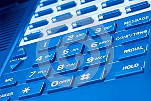 Close up of telephone keypad with blue hue