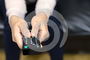 Close up Television remote control in casual woman