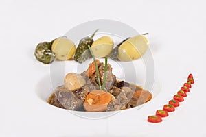 Close up of a tempting beef stew with an assortment of vegetables. Traditional food concept