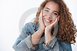 Close-up tender happy delighted excited charming curly-haired chubby girlfriend feeling upbeat touching cheeks joyfully