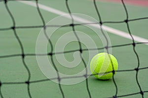Close up Tennis ball and blur net on court background