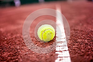 Close-up of tennis ball on the clay court