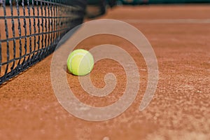 Close up of tennis ball on clay court