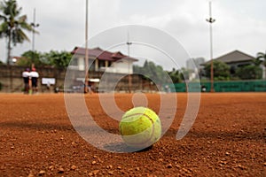 Close up of tennis ball on clay court. Tennis ball on a tennis clay court