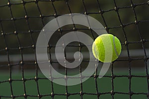 Close up tennis ball hitting to net on blur