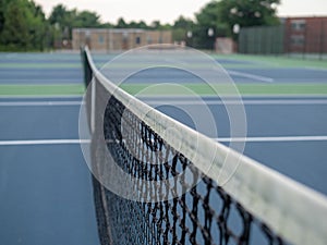 Close up of tennis court net and post in a local park