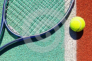 Close up of tennis racquet and ball