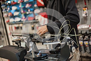 Close up of tennis stringer hands doing racket stringing