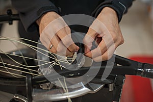 Close up of tennis stringer hands doing racket stringing