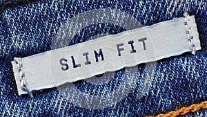 Close-up of a textile label with the inscription `Slim Fit`