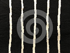 Texture of black carpet with white stripe