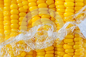 Close up texture of boiled sweet corn wrapped by plastic package