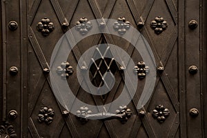 Close up texture of brown iron wrought and decorated door in european style