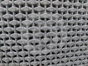 Close-up texture of grey plastic mesh pattern background