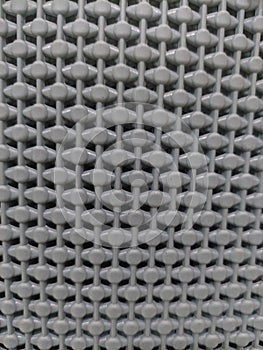 Close-up texture of grey plastic mesh pattern background
